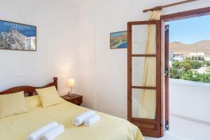 a bedroom with a bed with white towels on it at Studios Asterias 2 in Astypalaia