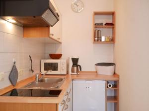 a small kitchen with a sink and a microwave at Ferienwohnung Ketterer in Breitnau