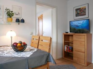 a room with a television and a bowl of fruit on a table at Ferienwohnung Ketterer in Breitnau