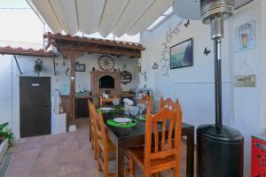 a kitchen and dining room with a table and chairs at Loft Cerca Del Mar Tenerife in Punta del Hidalgo +20 photos