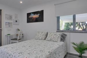 a bedroom with a bed and a window at Loft Cerca Del Mar Tenerife in Punta del Hidalgo