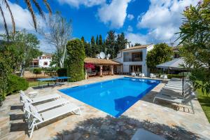 a villa with a swimming pool and a house at Can Toni in Pollença