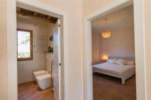 a bedroom with a bed and a bathroom with a sink at Al posto giusto - appartamento Sole in Riotorto +21 photos