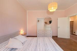 a bedroom with a large bed and a mirror at Al posto giusto - appartamento Sole in Riotorto