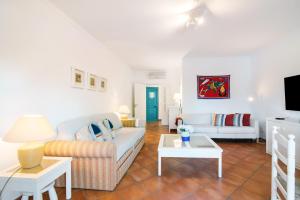 a living room with a couch and a table at Prainha Paradise - Algarve in Alvor