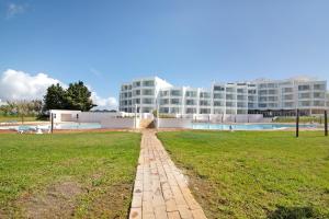 a brick pathway in front of a large building at Prainha Paradise - Algarve in Alvor