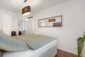 a bedroom with a bed and a mirror on the wall at Ferienwohnung in München Eg in Munich