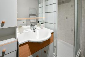 a bathroom with a sink and a shower at La Madély in Camiers +16 photos