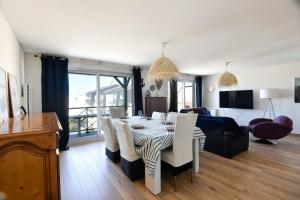 a living room with a table and chairs and a couch at La Madély in Camiers