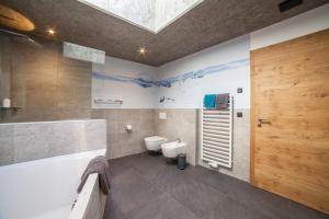 a bathroom with a toilet and a sink at Chalet Riad in Saltusio +28 photos