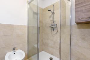 a bathroom with a shower with a toilet and a sink at Apartment Stuflesser in Laion