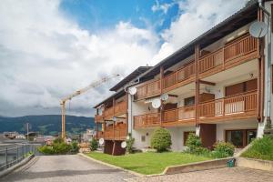 a building with a crane in the background at Apartment Stuflesser in Laion