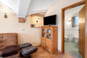 a living room with a couch and a flat screen tv at Ferienwohnung Ahrens in Ehrenberg