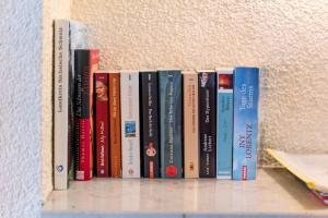 a row of books sitting on a shelf at Ferienwohnung Ahrens in Ehrenberg +13 photos