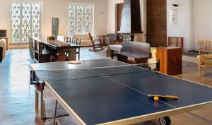 a ping pong table in the middle of a room at Agriturismo Monte Pu' in Castiglione Chiavarese