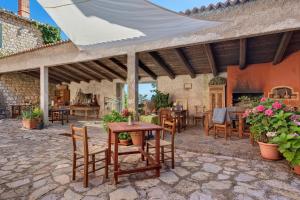 an outdoor patio with a table and chairs and a building at Agriturismo Monte Pu' in Castiglione Chiavarese