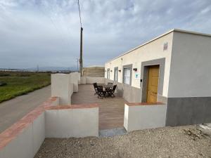 a building with a yellow door and a patio at Nido in Níjar