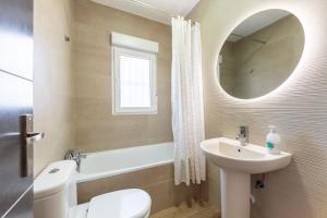 a bathroom with a sink and a toilet and a mirror at Nido in Níjar +10 photos
