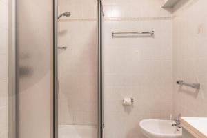 a bathroom with a shower and a toilet and a sink at Häuslerhof App Tilia in Villabassa