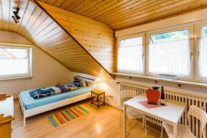 a bedroom in a tiny house with a bed and a table at Gala in Stockach