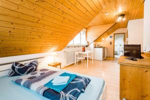 a bedroom with a bed and a wooden ceiling at Gala in Stockach