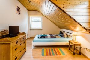 a bedroom with a bed with a wooden ceiling at Gala in Stockach