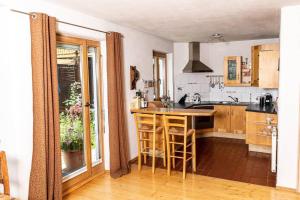 a kitchen with a island in the middle of a room at Haus Evelin in Kundl +11 photos
