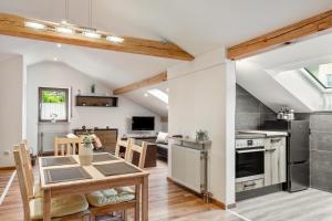 a kitchen and living room with a table and a dining room at Haus Erichsen in Perlesreut