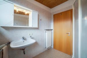 a bathroom with a sink and a mirror at Lingerhof Arnika in Meltina