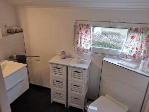 a small bathroom with a desk and a window at Haus am Hennesee in Meschede +12 photos