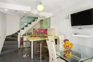 a kitchen with a glass table and a staircase at Playmar6970 in Maspalomas