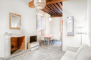 a living room with a fireplace and a table at Appartamento La Naiade, Lucca in Lucca