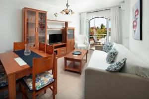 a living room with a couch and a table at Apartamento M 1 in Torrox Costa
