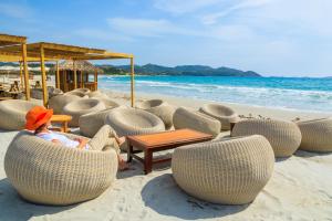 a person sitting in chairs on the beach at Villa Rokkaria in Villasimius