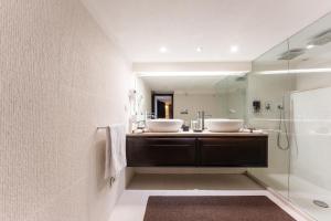a bathroom with two sinks and a shower at Villa Rokkaria in Villasimius +29 photos