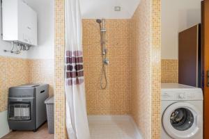 a bathroom with a shower and a washing machine at Gaia Casa Vacanze in San Giovanni Suergiu +14 photos