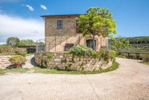 a stone retaining wall in front of a house at Podere del Pereto Bio- 203 in Rapolano Terme