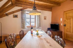 a dining room with a wooden table with wine glasses at Ferienwohnung Gschwand in Unterammergau