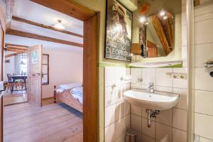 a bathroom with a sink and a bedroom at Ferienwohnung Gschwand in Unterammergau +16 photos