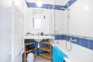 a bathroom with a sink and a tub and a toilet at La Cabine in Fouesnant +17 photos