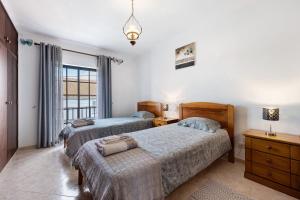 a bedroom with two beds and a window at Casa Brita in Raposeira