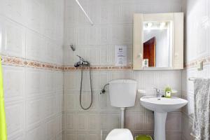 a bathroom with a shower and a toilet and a sink at Casa Brita in Raposeira +19 photos
