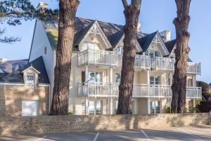a large house with trees in front of it at La Cabine in Fouesnant