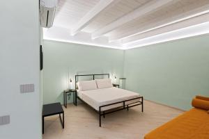 a bedroom with a bed in a white room at Dimora Storica Lucia in Ascea