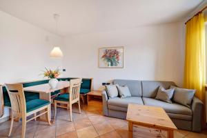 a living room with a couch and a table at Weinsepphof Ferienwohnung 4 in Lana