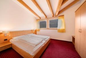 a small bedroom with a bed and a window at Weinsepphof Ferienwohnung 4 in Lana +16 photos