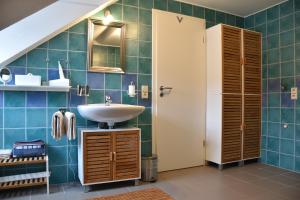 a bathroom with a sink and a mirror at Ferienwohnung Happynest in Birresborn +34 photos