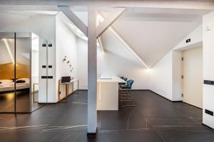 a room with white walls and a table and chairs at App 304 Palazzo Cavour in Bolzano +9 photos