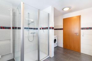 a bathroom with a shower and a glass door at Am Döttelbach in Bad Peterstal-Griesbach +32 photos