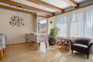 a living room with a chair and a table at Hotel Garni Vitamari in Wasserburg +143 photos